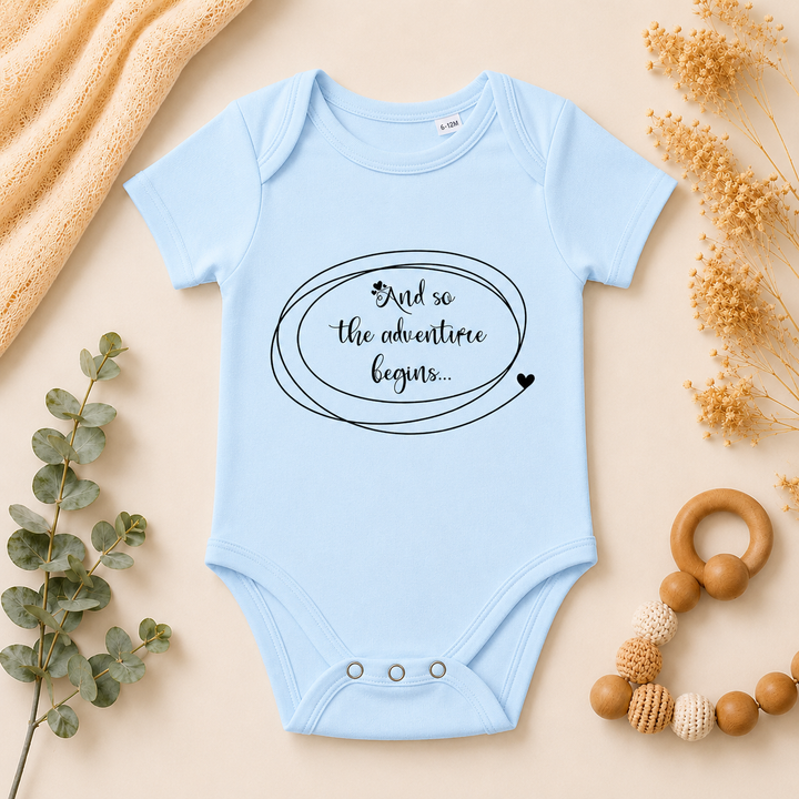 Babyblauw IVF rompertje met tekst “en zo begint het avontuur” als zwangerschapsaankondiging en cadeau voor wensouders