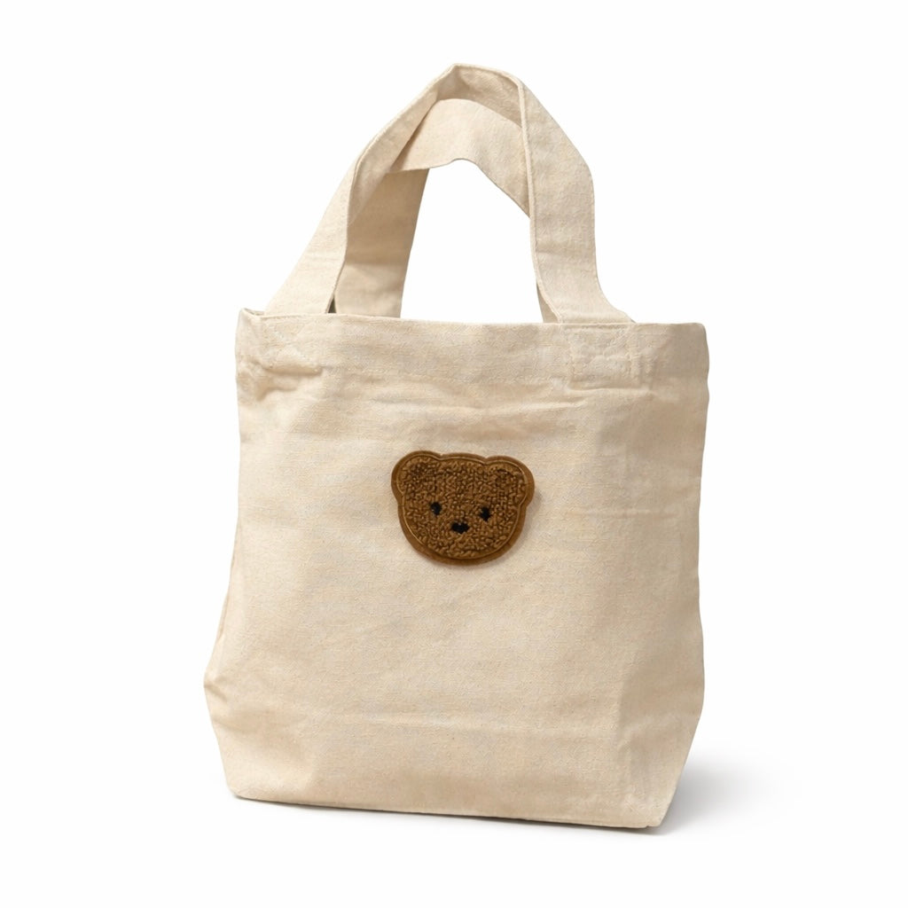 Naturelkleurig tasje met bruin beertje voor een gepersonaliseerd kraamcadeau