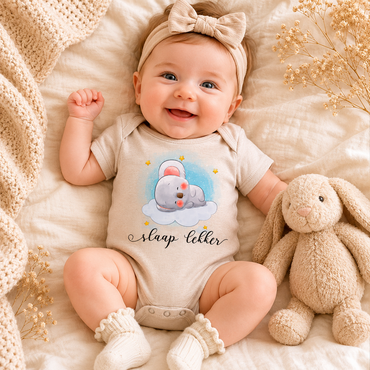 Baby draagt beige rompertje met ‘slaap lekker’ tekst en schattige muis op wolkje – zacht babyrompertje met print als kraamcadeau