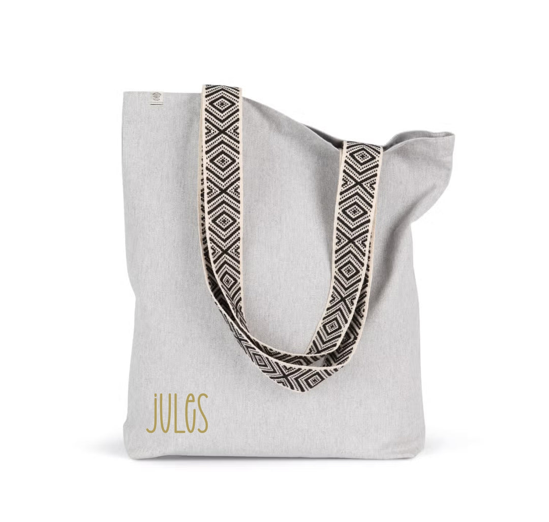 Shopper met naam JULES in goudkleurige opdruk op grijze shopper met zwart-wit patroonbanden